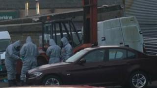 BMW car and police in chemical suits