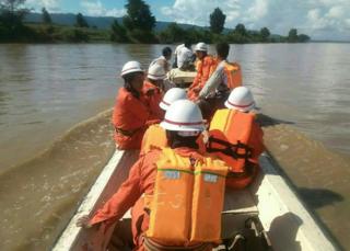 In this handout photograph released by the Myanmar Fire Services Department on October 17, 2016, government rescue personnel from the Myanmar Fire Services Department take part in a search operation on the Chindwin River after a ferry capsized near Monywa city in Sagaing region