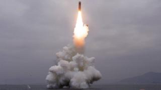What appears to be a submarine-launched ballistic missile (SLBM) flies in an undisclosed location in this undated picture released by North Korea's official news agency