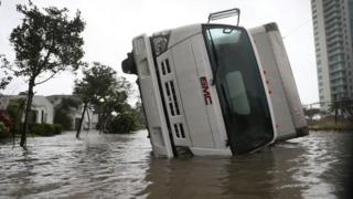 An overturned vehicle on a flooded street in Miami, Florida. Photo: 10 September 2017