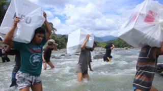 Indonesian workers transport ballot boxes for the upcoming general elections at the Bonto Matinggi village, Maros, South Sulawesi on April 16, 2019.