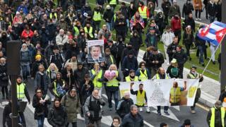 Yellow vest protesters march in Paris on November 16, 2019, to celebrate the first anniversary of the movement