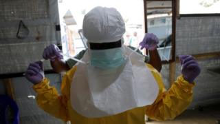 A health worker dons protective clothing in DR Congo