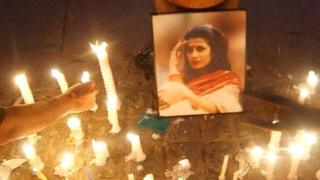 Indian protesters light candles around a photographs of murdered woman Jessica Lal during a protest at India Gate in New Delhi, 04 March 2006.