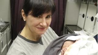 Alena Fedchenko with the baby boy on board a Qatar Airways flight