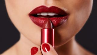 Mujer poniéndose lápiz labial