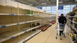 Man in front of empty shelves