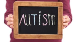 A chalkboard with the word autism on it