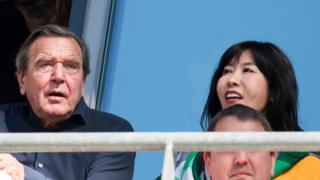 Gerhard Schroeder and his South Korean partner Kim So-Yeon watch the German first division Bundesliga football match between Hannover 96 and Bayern Munich on April 21, 2018.