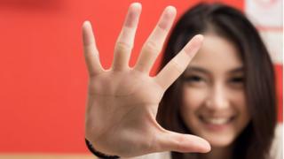 Woman holding out the fingers of her hand