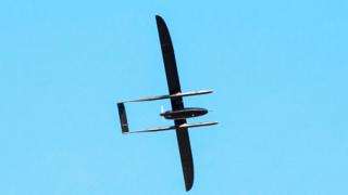 The offending UAV is seen in this photo silhouetted against a blue sky