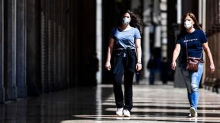 Woman walk in shopping arcade in Milan