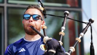 A Scotland fan plays bagpipes