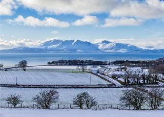 Looking over West Kilbride, North Ayrshire towards the Isle of Arran in the snow