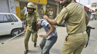 File photo - policemen beat a protester during a curfew in Jammu, India, on July 2, 2008.