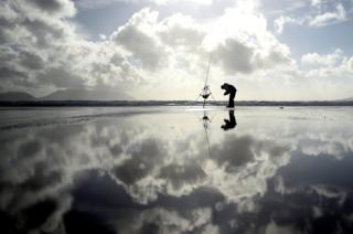 A man participates in the Diawa Irish Pairs sea angling event