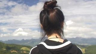 Now safely over the border Mira (L) and Jiyun (R) look out over a mountain range back towards China