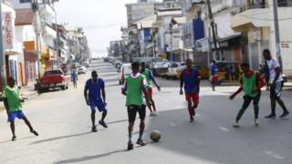 People playing football in the streets of Monrovia