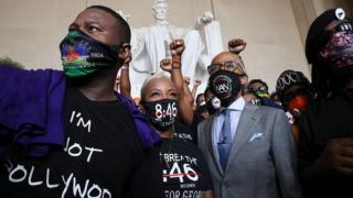 Rev Al Sharpton gathers with protesters in the Lincoln Memorial