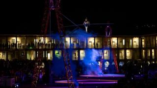 Man walking on a tightrope at The Piece Hall in Halifax