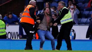 Fan taken away by police