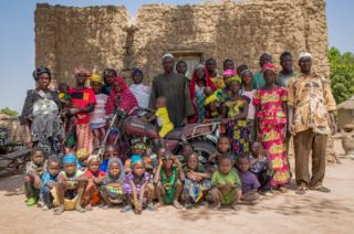Oumar, 56 (centre) and family