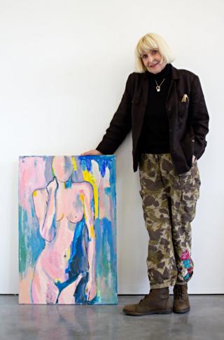 Geraldine Crimmins standing next to her artwork