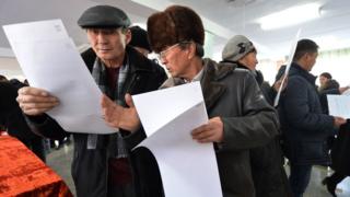 People vote at a polling station during the referendum on constitution change in the village of Baytik some 20 km from Bishkek on December 11, 2016.