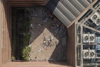 An aerial view shows the main entrance (top R) to the campus and debris leftover from protesters who barricaded themselves inside, at the Hong Kong Polytechnic University in the Hung Hom district in Hong Kong on 22 November 2019.