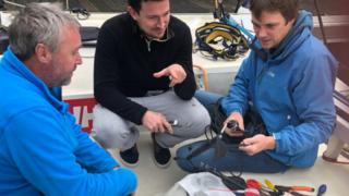 Alex Alley (left) being helped by locals in Brest