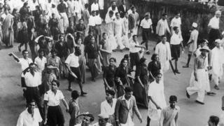 Women volunteers from Congress walk through the streets of Bombay shouting slogans during disturbances in the city.