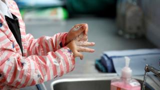 Child washes hands at school