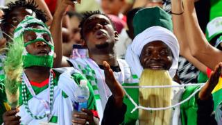 A Nigeria supporter cheers during the 2019 Africa Cup of Nations (CAN) quarter final football match between Nigeria and South Africa at Cairo international stadium on July 9, 2019.