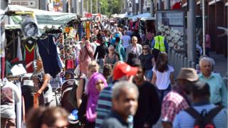 People walk through Walthamstow market