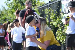 Eltern bringen Kinder in die Queen's Hill Grundschule in Norfolk