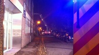 Work is done by firefighters to fix the roof at the property