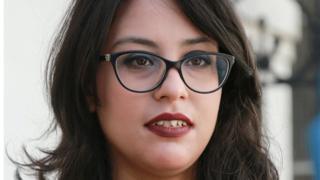 Emna Charqui, who was charged with offending common decency and incitement to violence, speaks to reporters outside a court in the capital Tunis, 28 May 2020