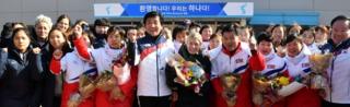 Sarah Murray, head coach of the combined women's ice hockey team, is seen as the North Korean women's ice hockey players arrive at South Korea's national training centre in Jinchoen on 25 January 2018