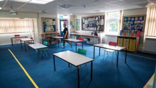 A headteacher in an empty classroom