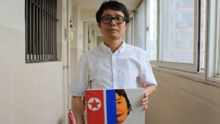 Song Byeok holds up one of his North Korean propaganda pieces