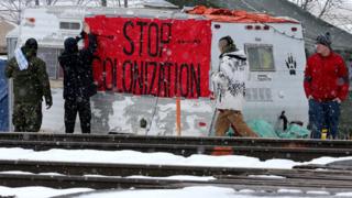 First Nations members of the Tyendinaga Mohawk Territory place a sign at a blockade of train tracks