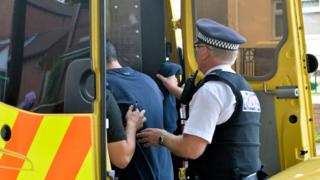 Suspect put into police van