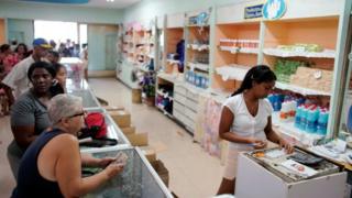 Cubans queue for products in a state shop in Havana