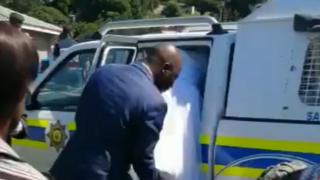 The bride getting into a police vehicle
