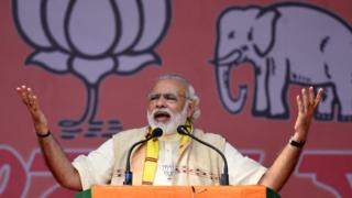 India's Prime Minister Narendra Modi gestures as he addresses an election rally at Majuli Island on March 26, 2016, ahead of state assembly elections in Assam.