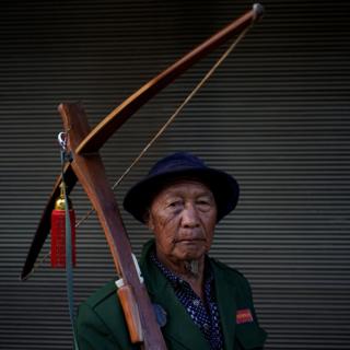 An ethnic Lisu man carries his crossbow