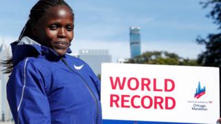 Kenya's Brigid Kosgei smiles after winning the women's 2019 Chicago Marathon - 13 October 2019