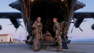 RAF personnel board the C-130 bound for Sudan as it prepares to depart RAF Akrotiri on C-130 Hercules aircraft