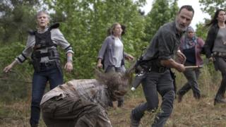 Rick Grimes kills a zombie with an ax