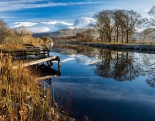The serene Caledonian Canal is pictured by Angus Chisholm with a snow covered Ben Nevis in the background